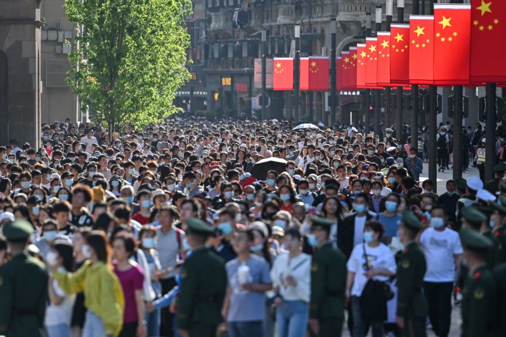 People walk along a pedestrian street during a labour day holiday in Shanghai on May 1, 2021.